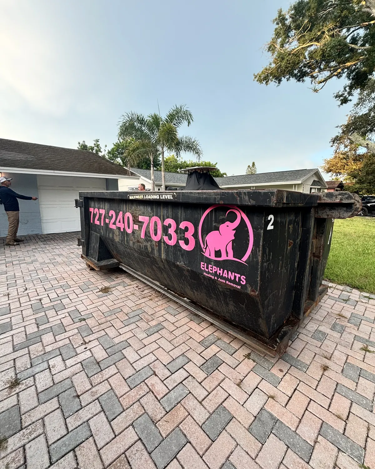 Elephants Dumpster Rental roll-off dumpster on a paver brick driveway in St. Petersburg FL